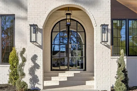 a living room with lots of furniture and a large window