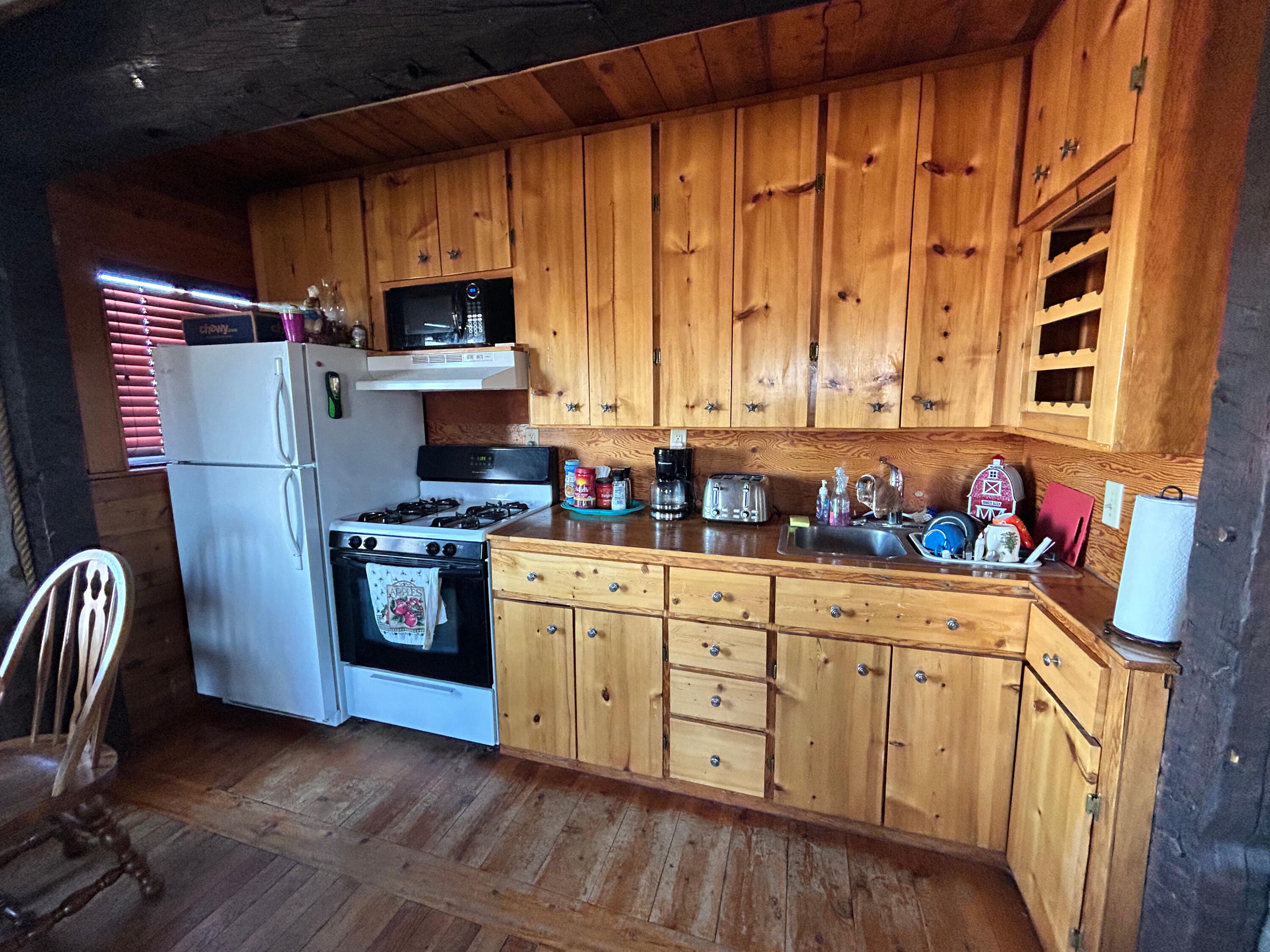 553-185 Punkin Center Road Bieber, CA 96009 - Photo 57 of 57 a kitchen with stainless steel appliances granite countertop a refrigerator a sink dishwasher a stove and white countertops with wooden floor