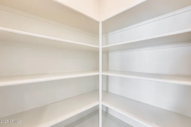 a view of kitchen with refrigerator and cabinets