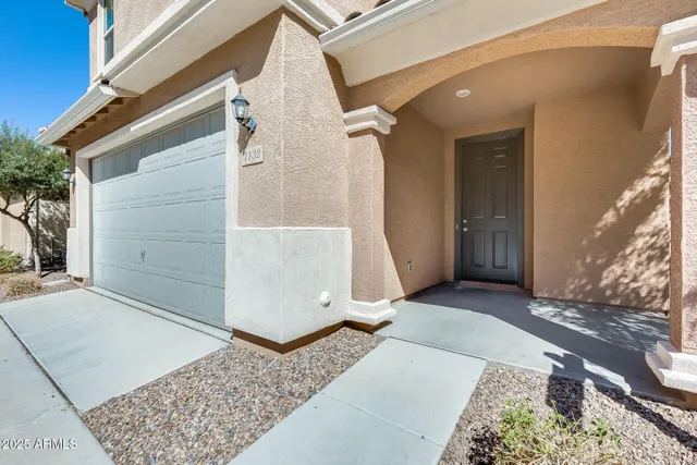 a view of a patio with table and chairs under an umbrella