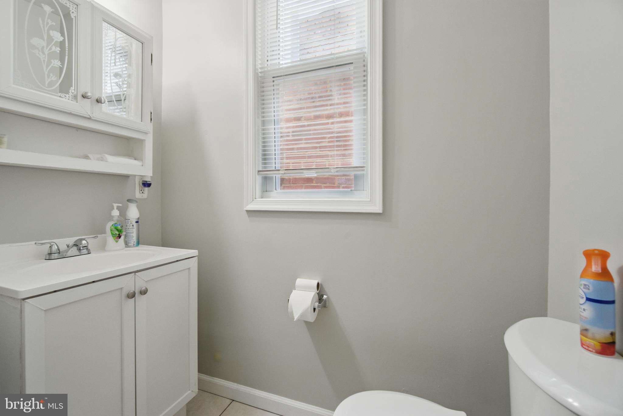 28 T Street Northwest, Unit 3 Washington, DC 20001 - Photo 15 of 34 a bathroom with a sink a toilet and a window