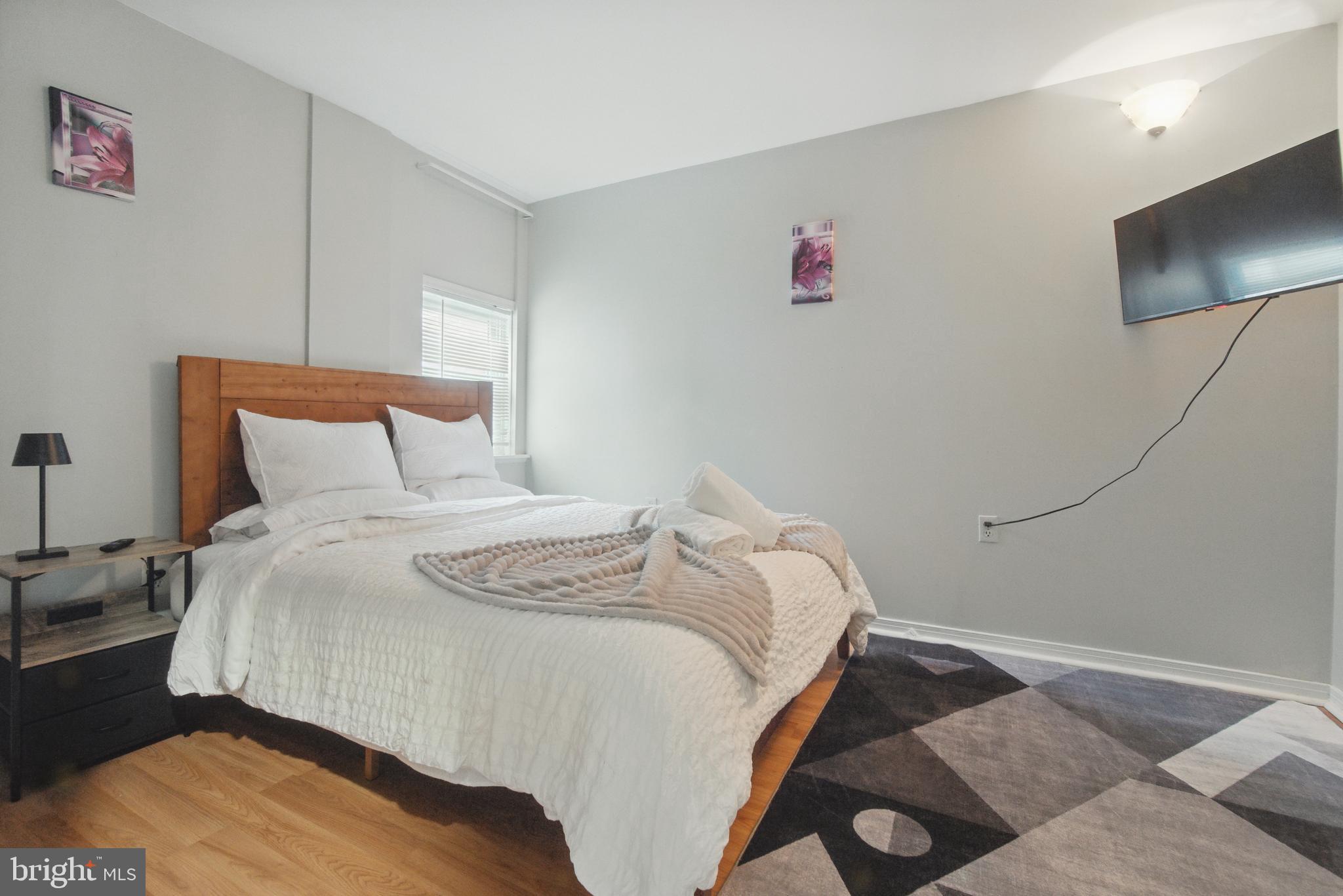 28 T Street Northwest, Unit 3 Washington, DC 20001 - Photo 17 of 34 a bedroom with a bed and a flat screen tv