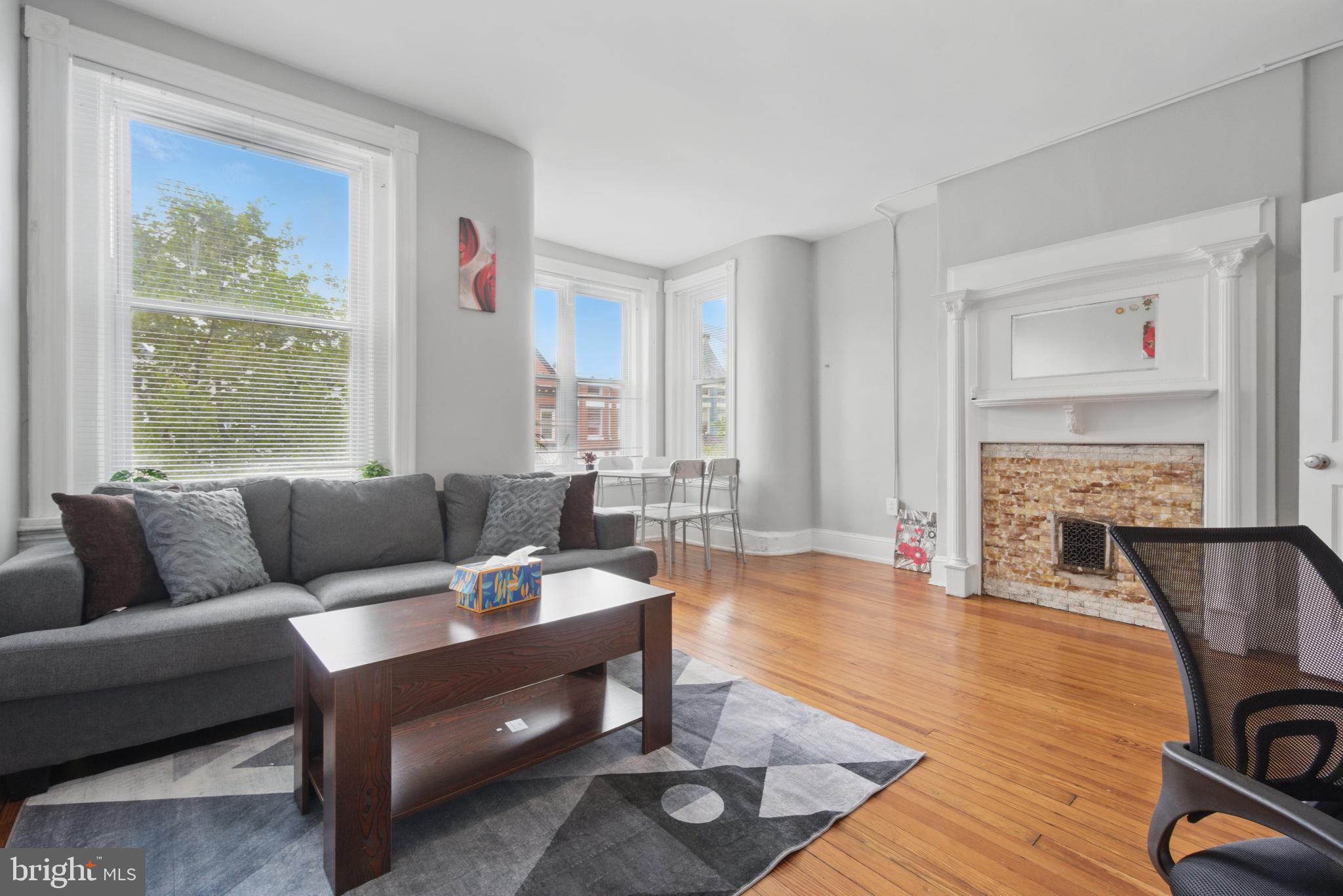 28 T Street Northwest, Unit 3 Washington, DC 20001 - Photo 2 of 34 a living room with furniture a fireplace and a table