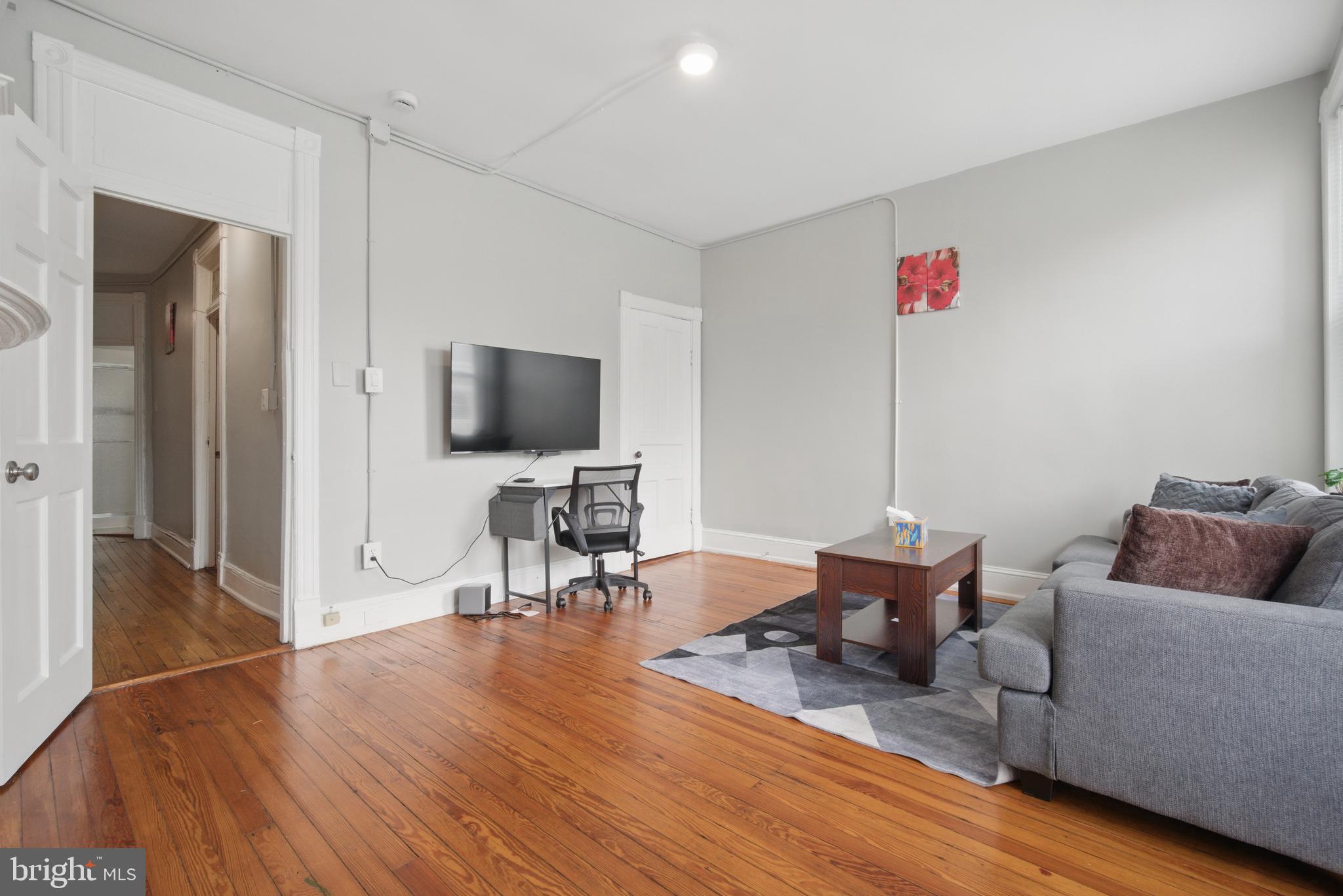 28 T Street Northwest, Unit 3 Washington, DC 20001 - Photo 21 of 34 a living room with furniture and a flat screen tv