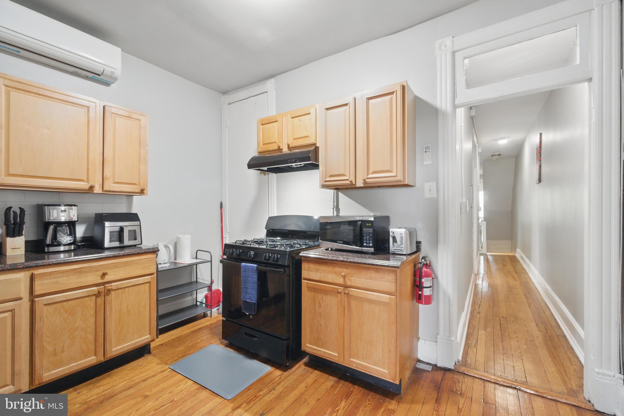 28 T Street Northwest, Unit 3 Washington, DC 20001 - Photo 3 of 34 a kitchen with stainless steel appliances granite countertop a stove top oven a sink dishwasher and cabinets with wooden floor