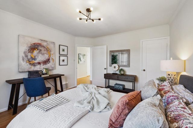 a bedroom with a bed and wooden table