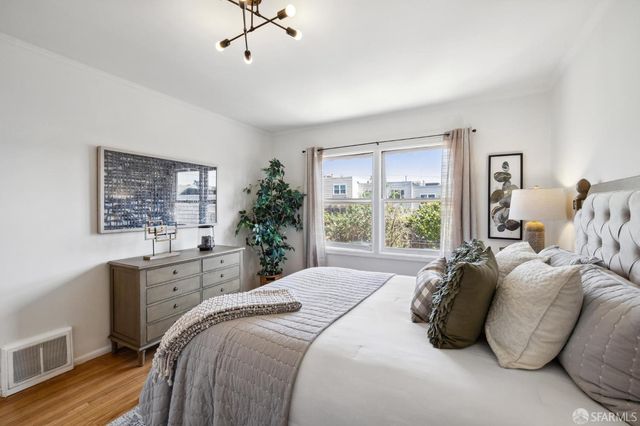 a bedroom with a large bed and a window