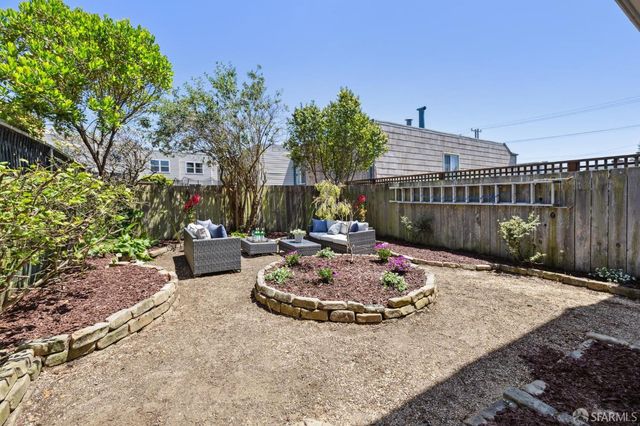 a wooden bench sitting in front of a building