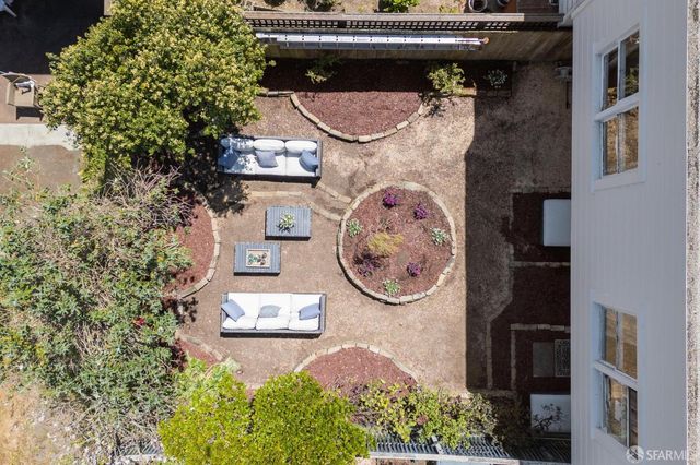 an aerial view of a house with wooden floor and outdoor space