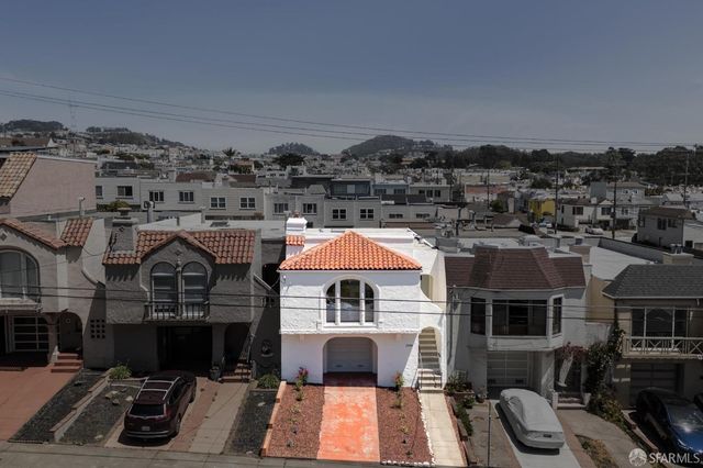 an aerial view of a house with a yard