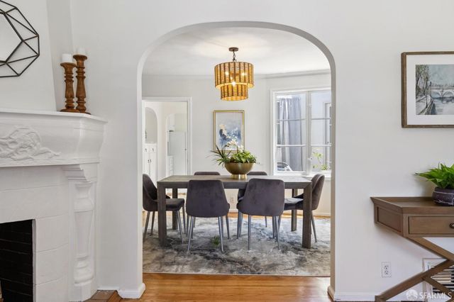 a view of a dining room with furniture and chandelier