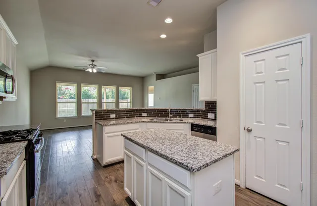 a kitchen with a stove and a center island