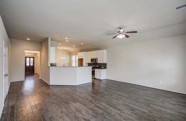 a view of kitchen with cabinets and wooden floor