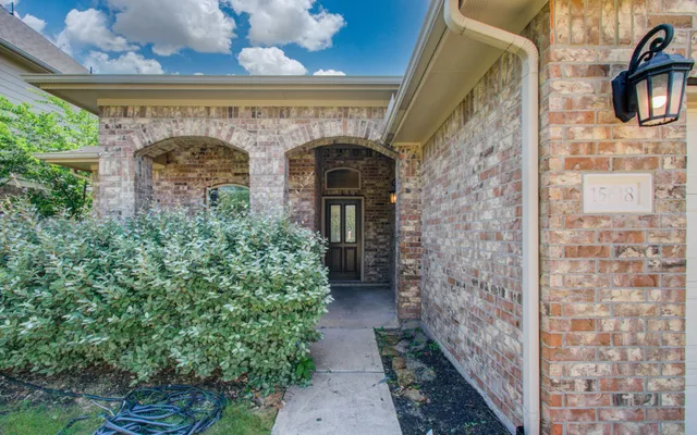 a front view of a house with plants