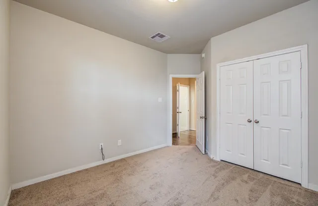 a view of an empty room and closet area