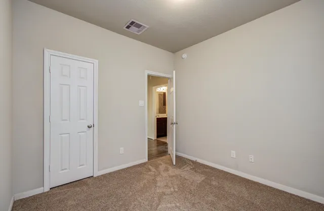 a view of a backyard with wooden fence