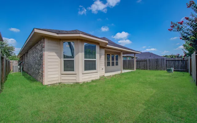 a view of a backyard with wooden fence
