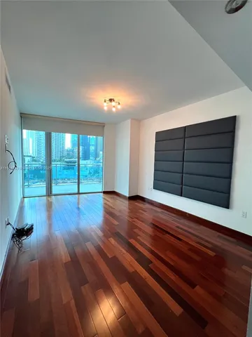 a view of room with wooden floor and window