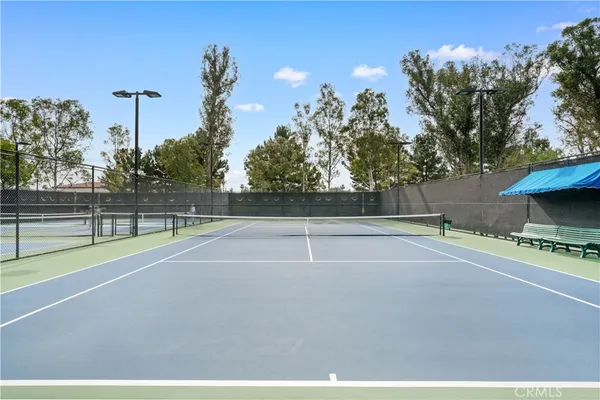 a front view of a building with cars parked
