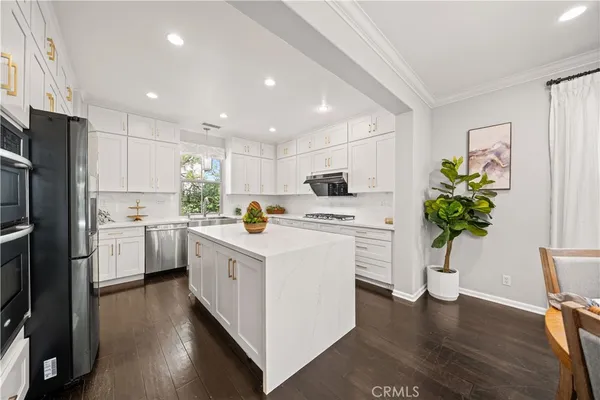 a kitchen with white cabinets and white appliances