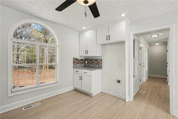 a view of a kitchen with a dishwasher cabinets and a large window
