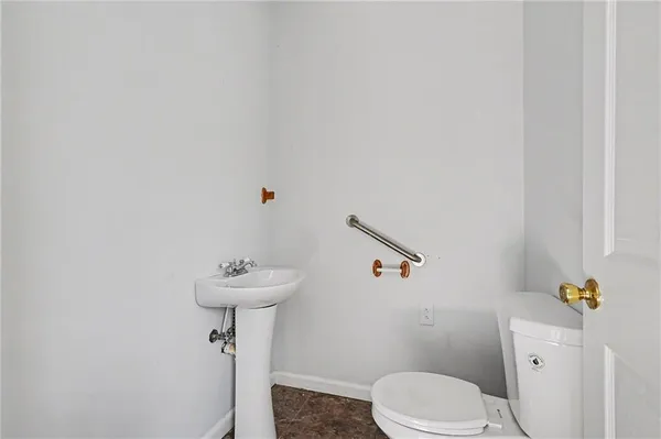 a bathroom with a sink toilet and a mirror