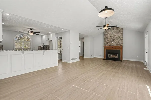 a view of a kitchen with cabinets and wooden floor