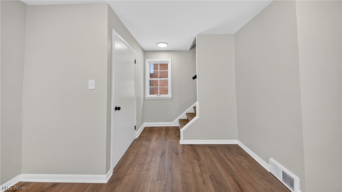 16811 Invermere Avenue Cleveland, OH 44128 - Photo 19 of 47 Hallway featuring dark wood-style flooring and stairs