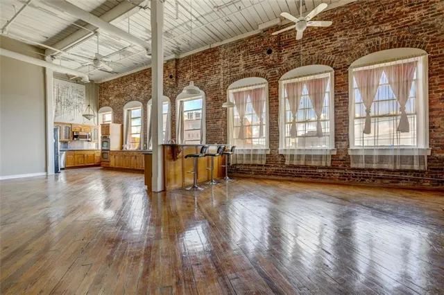 a view of empty room with wooden floor and windows