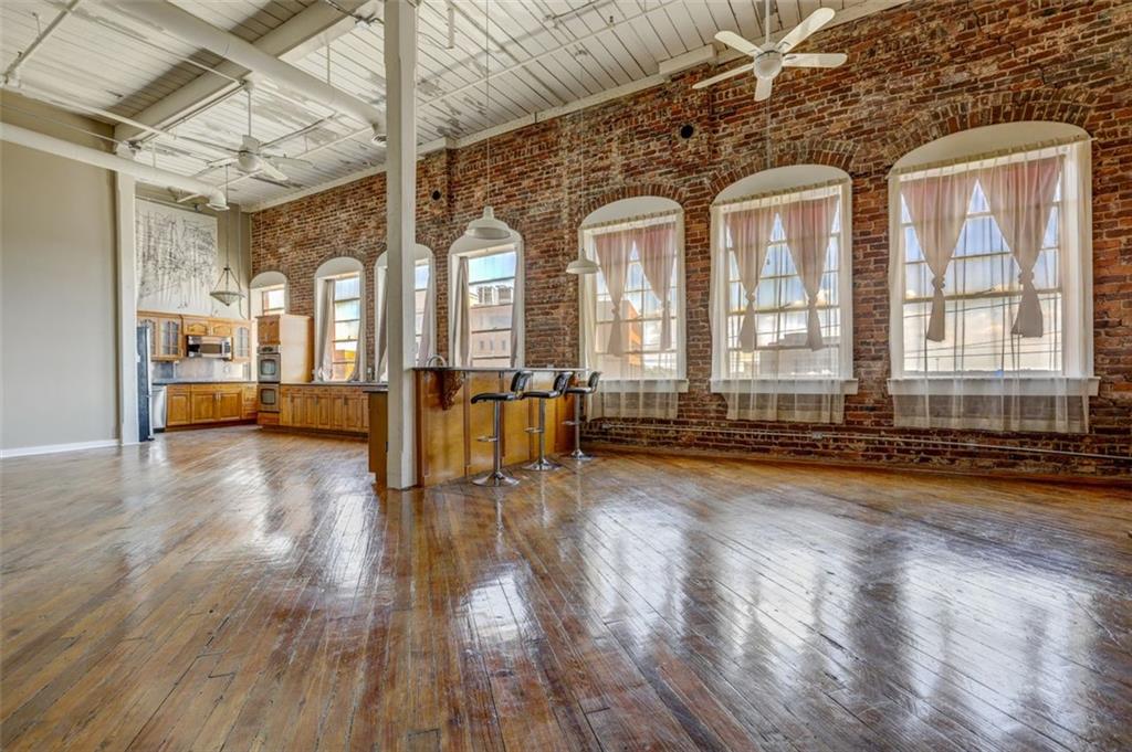 a view of empty room with wooden floor and windows