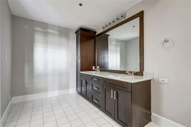 a spacious bathroom with a mirror and a sink