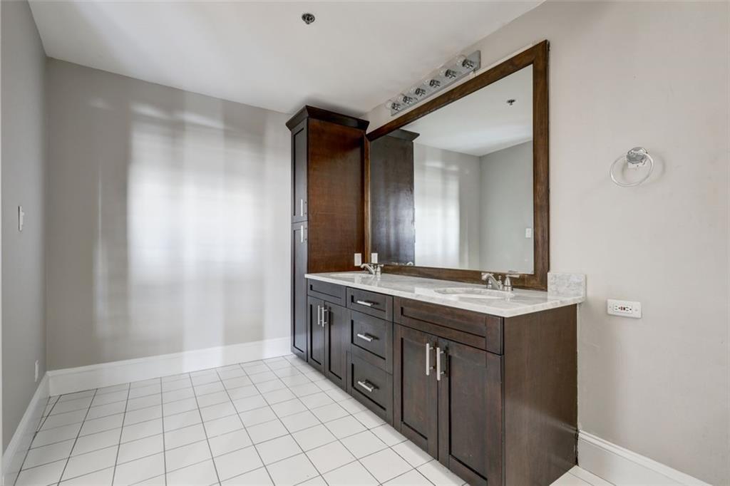 161 Mangum Street Southwest, Unit 302 Atlanta, GA 30313 - Photo 14 of 33 a spacious bathroom with a mirror and a sink