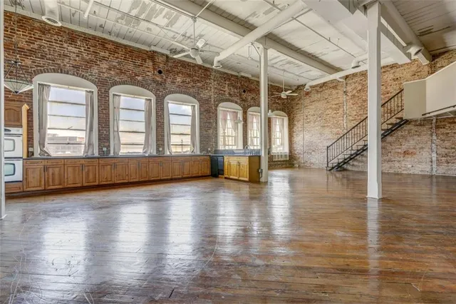 a view of a living room with hardwood floor and staircase