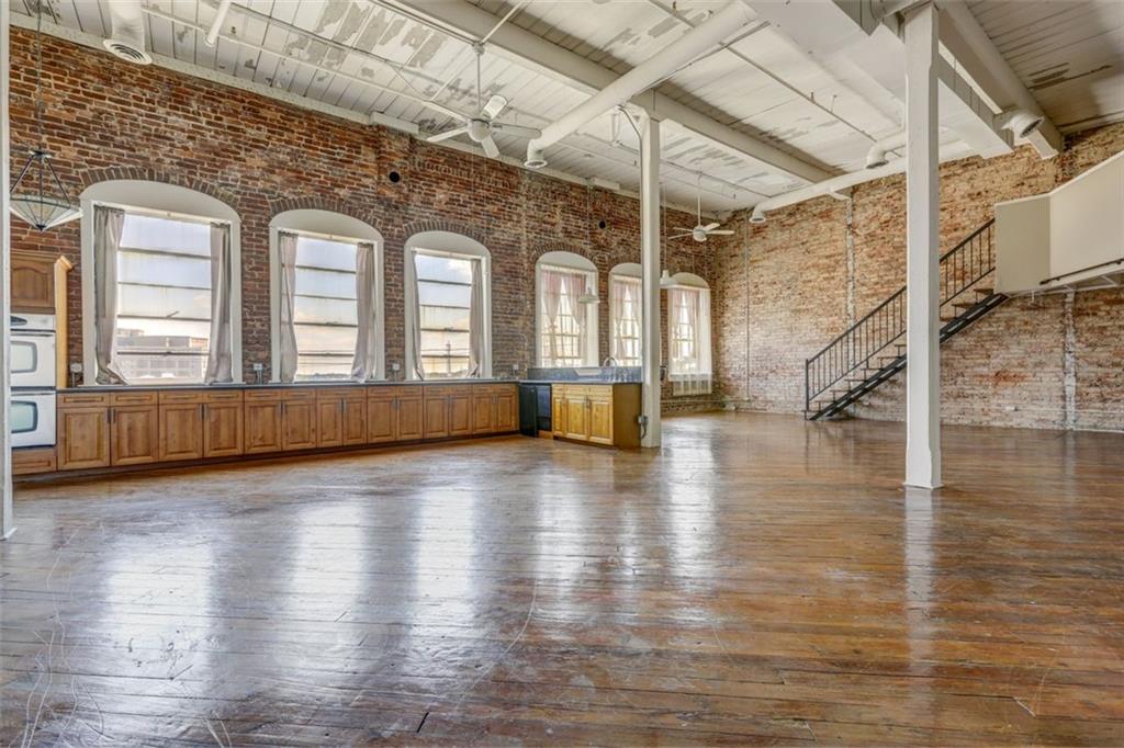 161 Mangum Street Southwest, Unit 302 Atlanta, GA 30313 - Photo 15 of 33 a view of a living room with hardwood floor and staircase