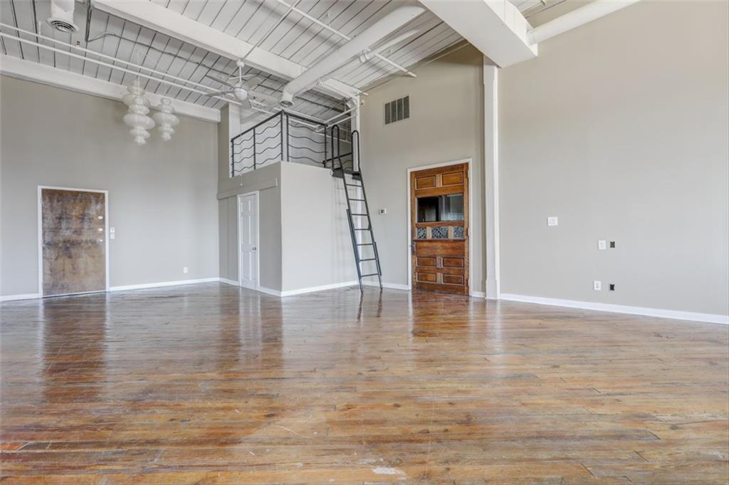 161 Mangum Street Southwest, Unit 302 Atlanta, GA 30313 - Photo 17 of 33 a view of an empty room with wooden floor and a window