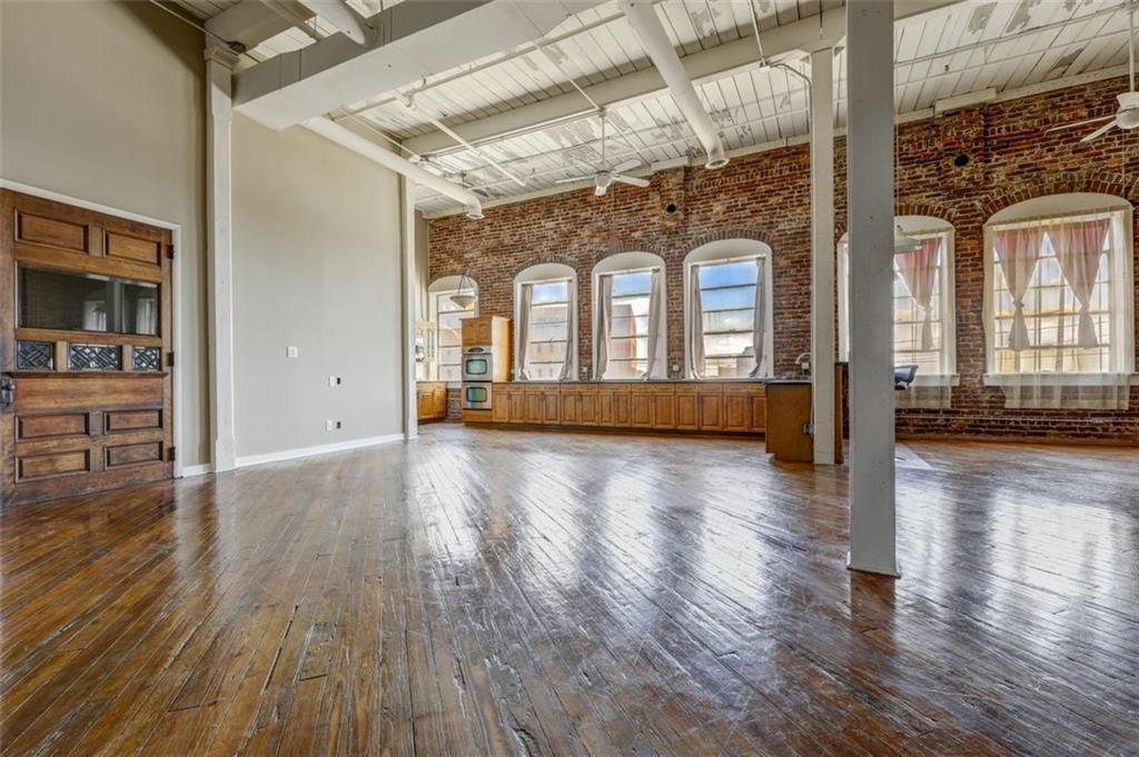 161 Mangum Street Southwest, Unit 302 Atlanta, GA 30313 - Photo 2 of 33 a view of a living room with hardwood floor and windows