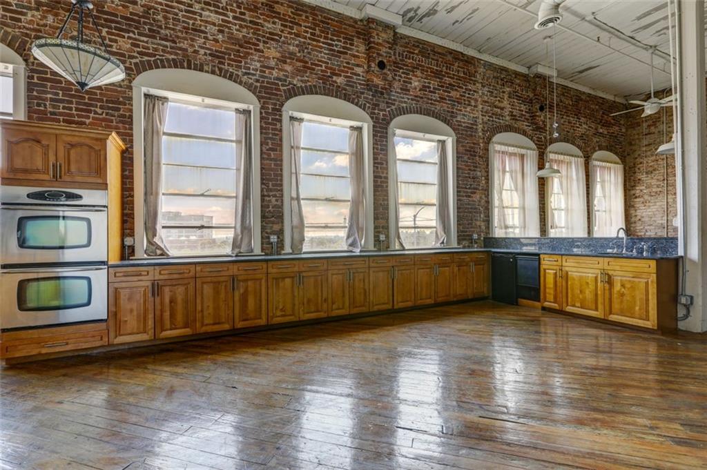 161 Mangum Street Southwest, Unit 302 Atlanta, GA 30313 - Photo 3 of 33 a view of an empty room with wooden floor and a window