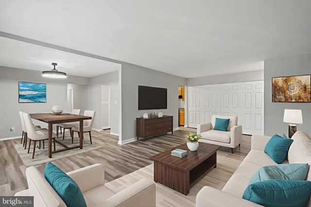 a living room with furniture a rug and a flat screen tv