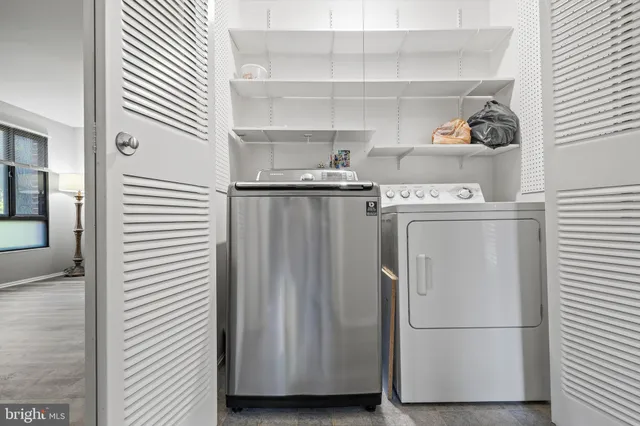 a view of storage and utility room with washer and dryer