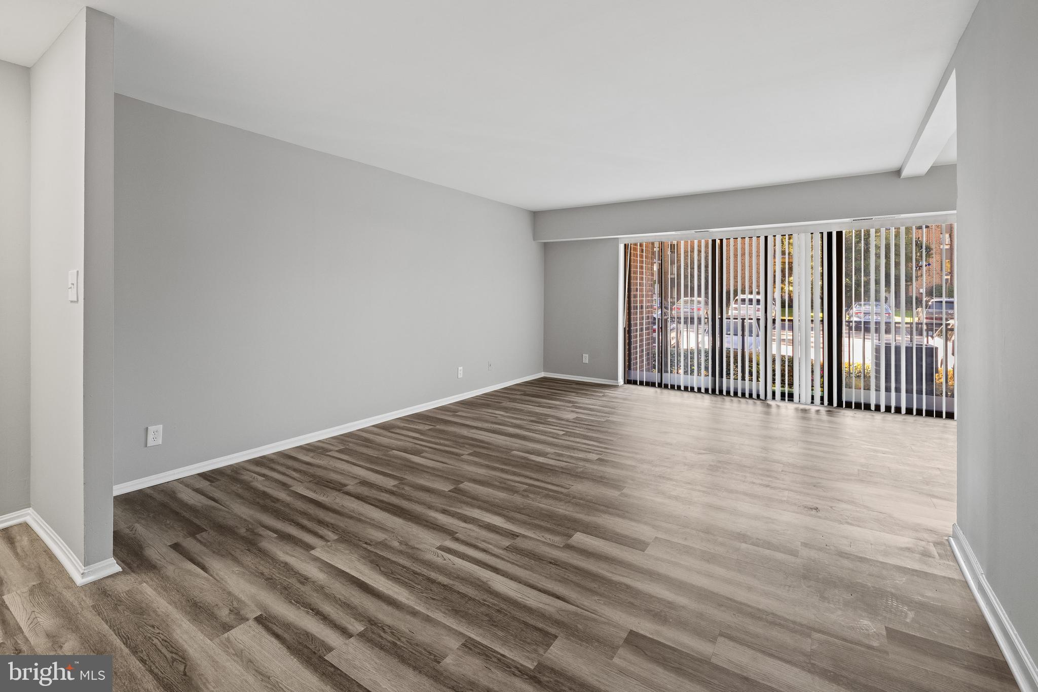 7804 Inverton Road, Unit 201 Annandale, VA 22003 - Photo 2 of 16 a view of an empty room with wooden floor and a window