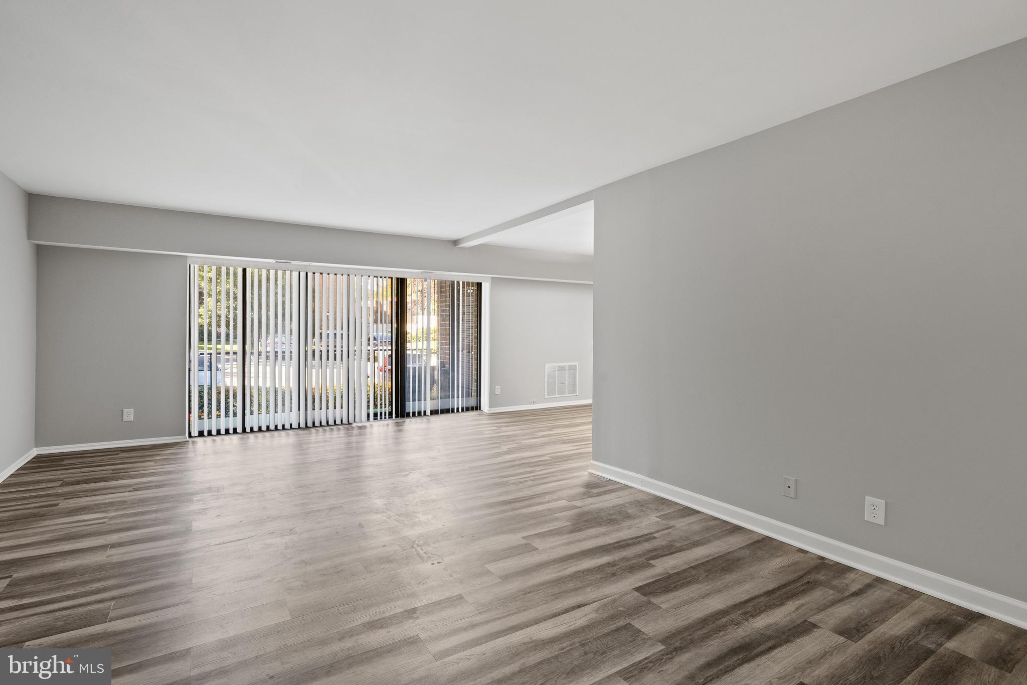 7804 Inverton Road, Unit 201 Annandale, VA 22003 - Photo 4 of 16 a view of an empty room with wooden floor and a window