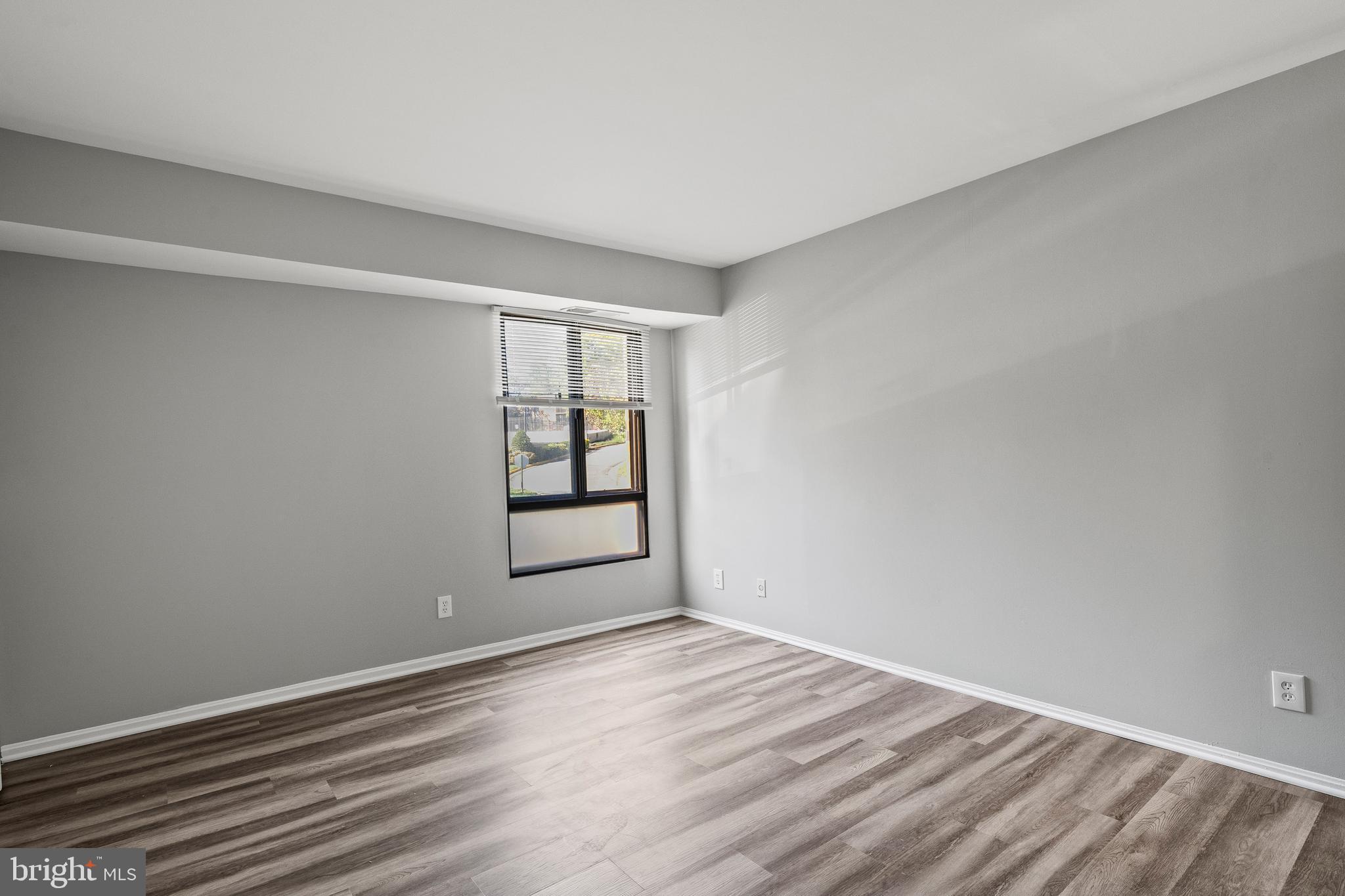 7804 Inverton Road, Unit 201 Annandale, VA 22003 - Photo 8 of 16 a view of empty room with wooden floor and fan