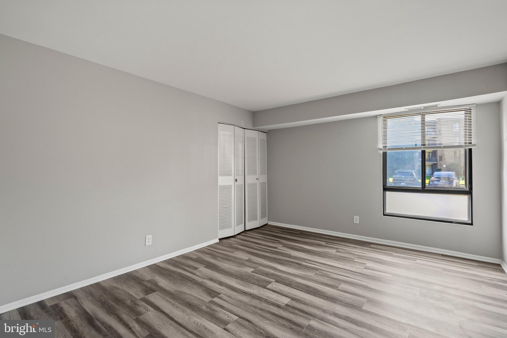 7804 Inverton Road, Unit 201 Annandale, VA 22003 - Photo 9 of 16 a view of an empty room with window and wooden floor