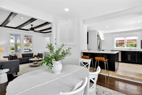 a living room with furniture a potted plant and a table