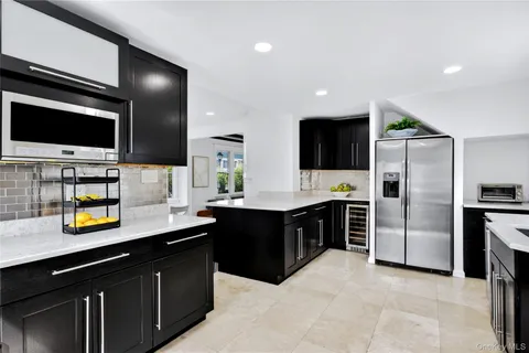 a kitchen with a sink stainless steel appliances and cabinets