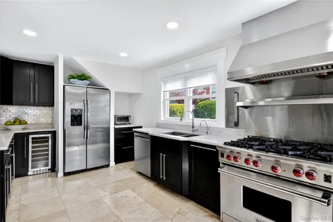 a kitchen with a stove a sink and a refrigerator