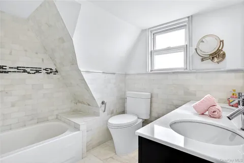 a bathroom with a sink a toilet and bathtub