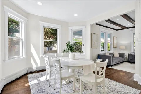 a view of a dining room with furniture window and wooden floor