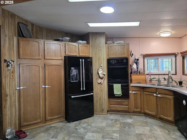 a kitchen with stainless steel appliances granite countertop a refrigerator stove and sink