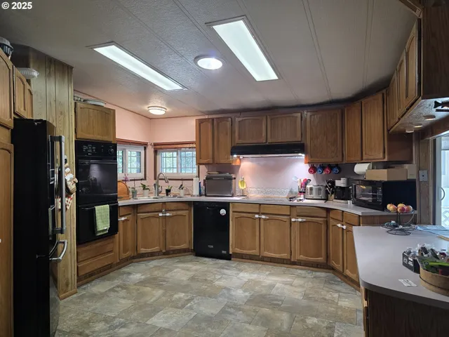 a view of a dining room with furniture and a chandelier
